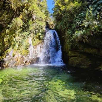a large waterfall over some water