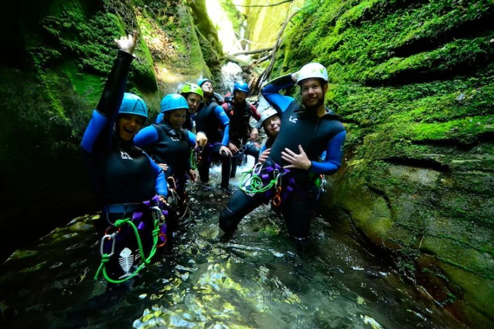 a man riding a motorcycle down a river