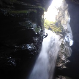 a large waterfall over some water