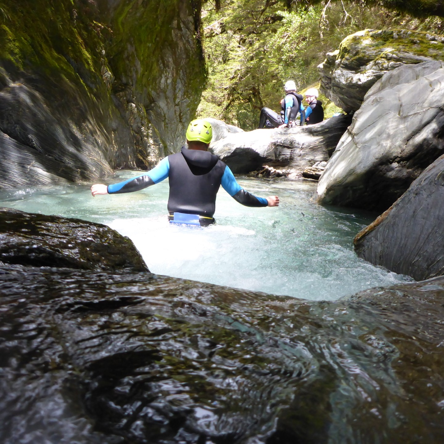 a man standing next to a waterfall