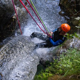 a man abseiling a waterfall
