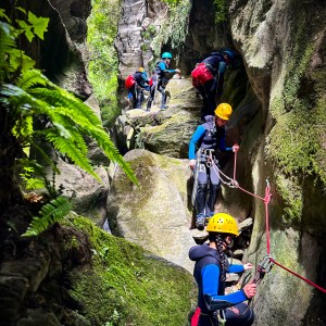 a group of people climbing through the canyon