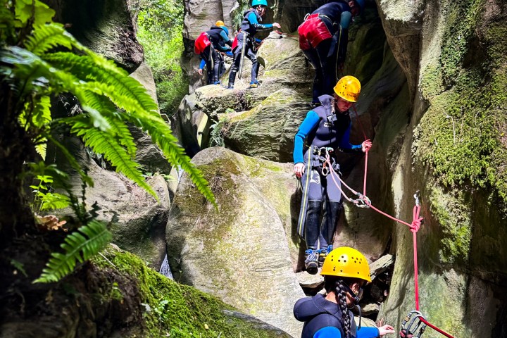 a group of people climbing through the canyon