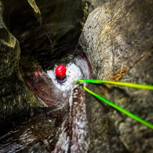 Watching from the top as someone slides into the canyon