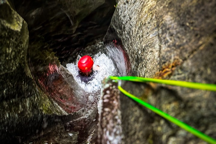 Watching from the top as someone slides into the canyon