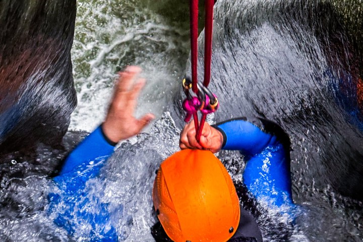 A person getting ready to slide into the canyon