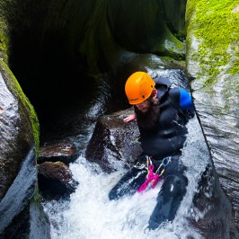 a person climbing through the canyon