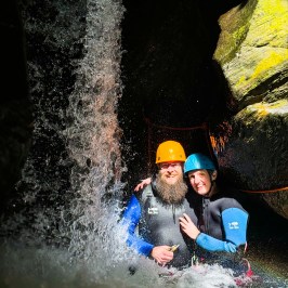 Two people getting a picture in the waterfall