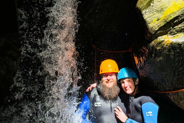 Two people getting a picture in the waterfall