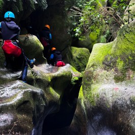 a group of people climbing through the canyon