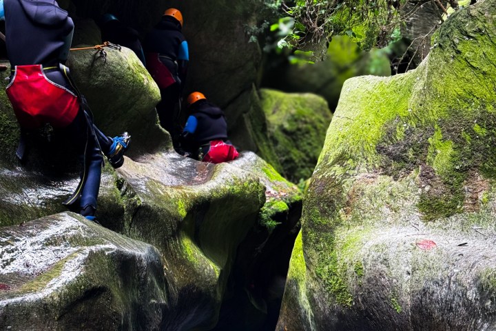 a group of people climbing through the canyon