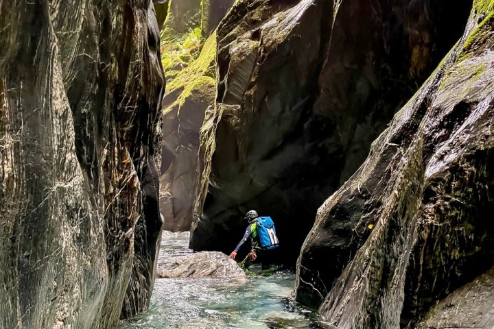 a person standing next to a waterfall
