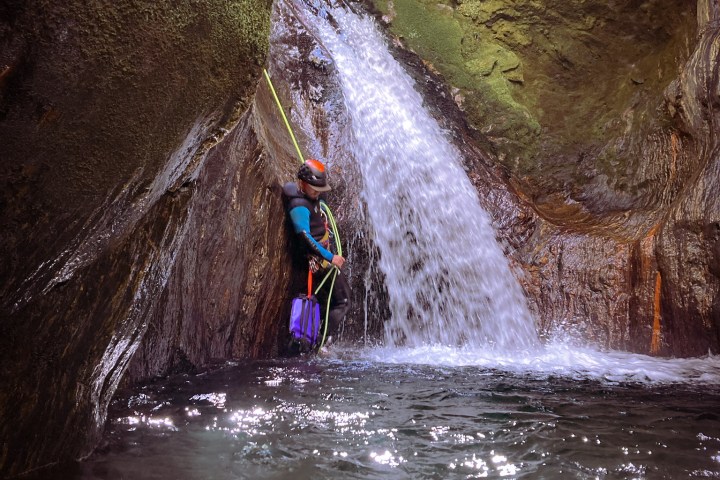 a person riding on the back of a waterfall