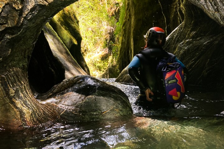 a person standing next to a body of water