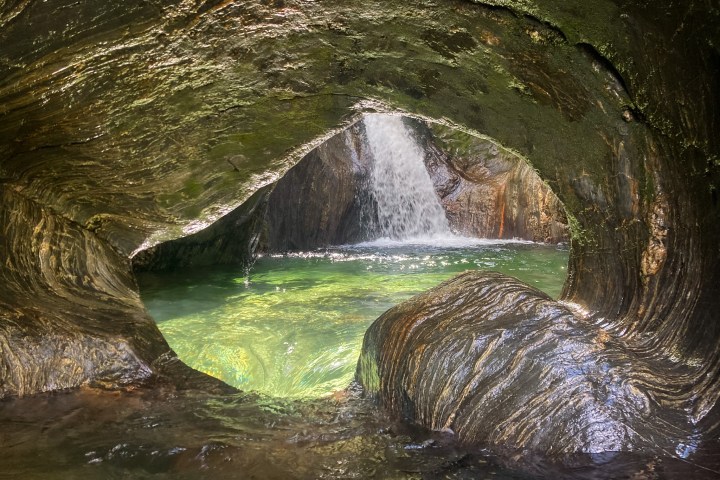 a large waterfall over a body of water