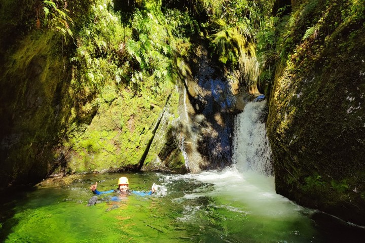 a large waterfall over a body of water