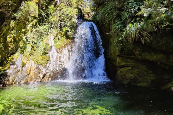 a large waterfall over some water