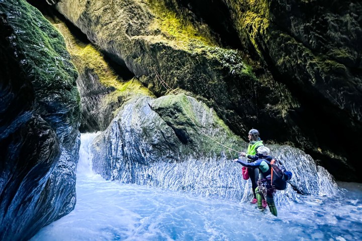 a group of people riding on the back of a waterfall