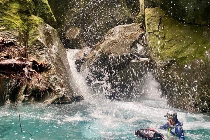 a group of people riding on the back of a waterfall