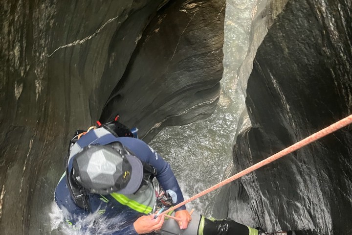 a man riding skis down a river next to a body of water