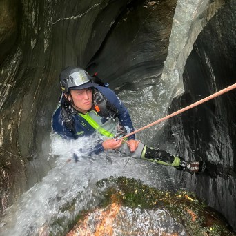 A man abseiling down the canyon