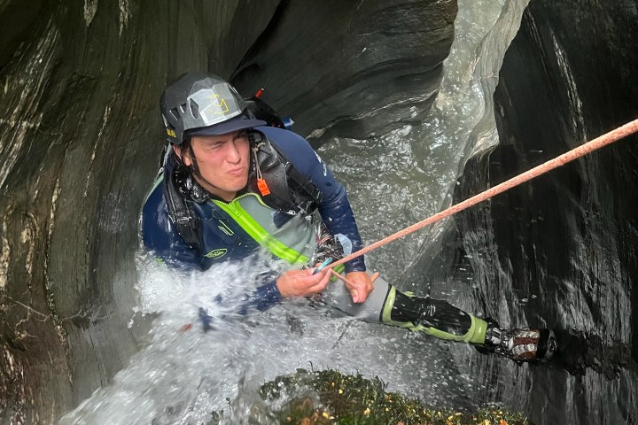 A man abseiling down the canyon