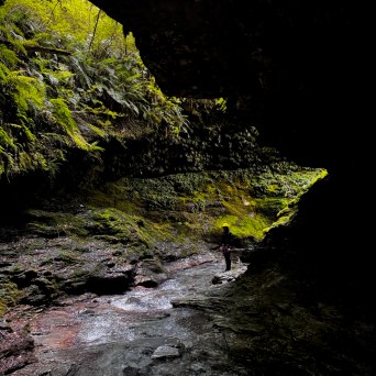 a large waterfall over a body of water