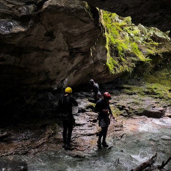 a man standing next to a waterfall