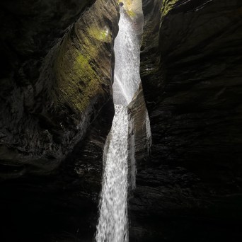 a large waterfall over a body of water