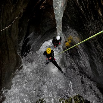 a person standing next to a waterfall