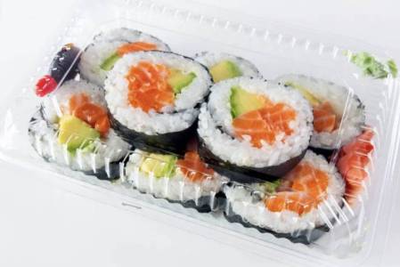 Sushi rolls with salmon and avocado in a plastic container with wasabi and ginger.